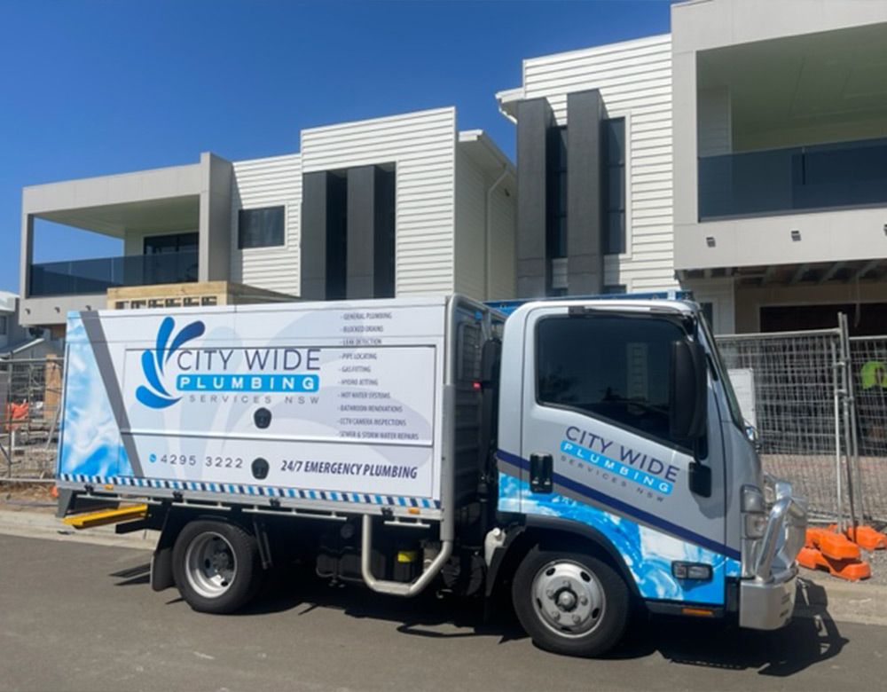 CityWide plumbing truck parked outside a house